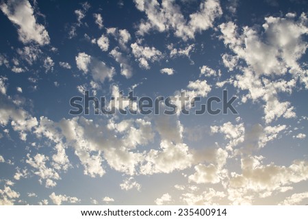 Beautiful white clouds on a blue sky background .