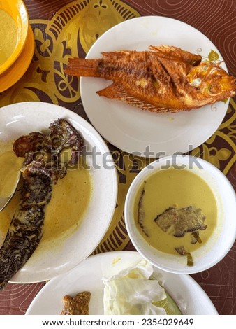 Assorted malay traditional cuisine, fried talapia, smoke cat fish masak lemak cili api, daging salai with rice 