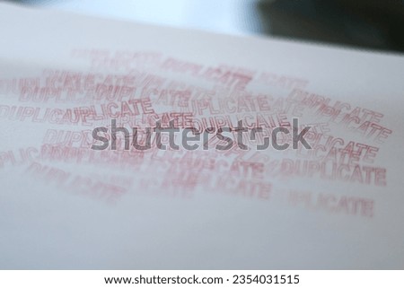 DUPLICATE red rubber stamp over a white background. Royalty-Free Stock Photo #2354031515