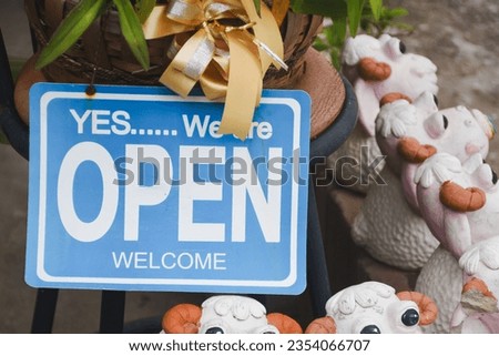 Store opening sign, "Welcome" and "Open"