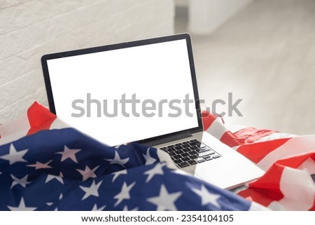 Laptop with blank screen and USA flag