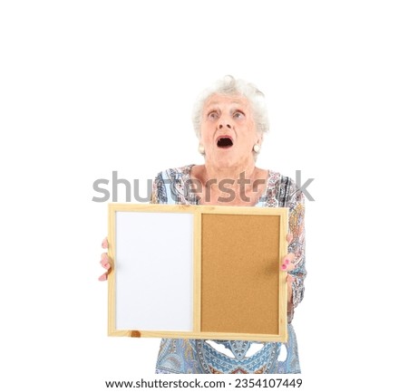 Surprised old woman looking up while holding a board against a white background