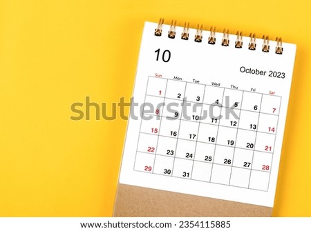 October 2023 Monthly desk calendar for 2023 year on yellow background.