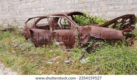 Mysuru, Karnataka, India-July 5 2023; A Dramatic picture of an abandoned Sedan Car in rusty condition left as scrap after an accident in India.