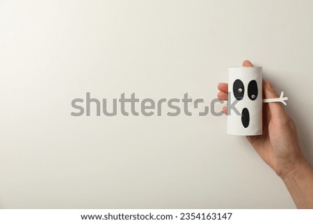 Ghost mockup in hand on white background, space for text