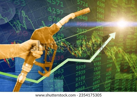 crude oil retail price increase rise high concept, green businees stock chart overlay hand with fuel nozzle up arrow. Royalty-Free Stock Photo #2354175305