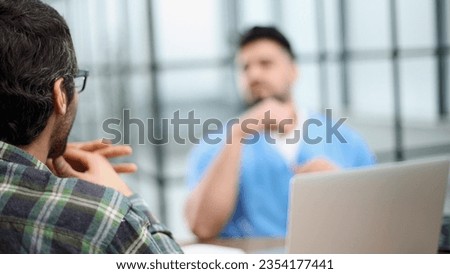 Doctor talking to a patient in a consultation at the office