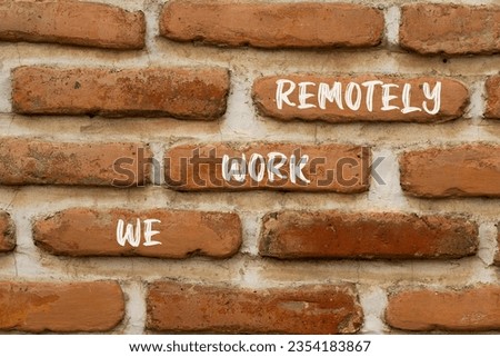 We work remotely symbol. Concept words We work remotely on beautiful brown brick. Beautiful red brown brickwall background. Business we work remotely concept. Copy space.