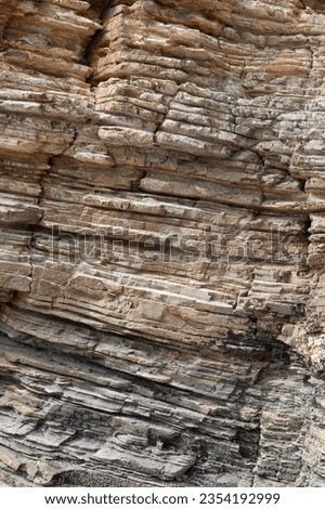 Eroded cliff wall. Stone layers close-up.