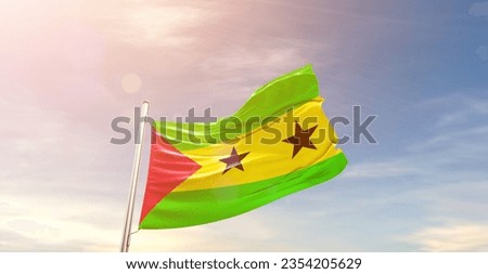 Sao Tome and Principe national flag waving in beautiful sky.