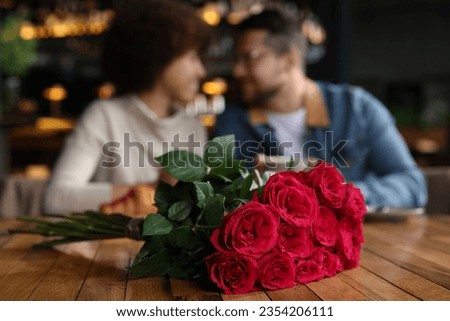 International dating. Happy couple spending time together in restaurant, selective focus Royalty-Free Stock Photo #2354206111