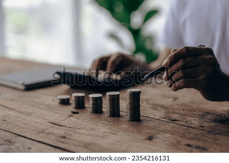 pile of coins on table with calculator saving money and coin investment concept on table saving money economy investment growing business and wealth