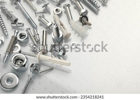 Many different fasteners on plastic surface, closeup. Space for text Royalty-Free Stock Photo #2354218241