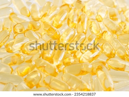 Cod-liver oil (vitamin D, E, A, cosmetic serum) supplement softgel capsules. Close-up, selective focus Royalty-Free Stock Photo #2354218837