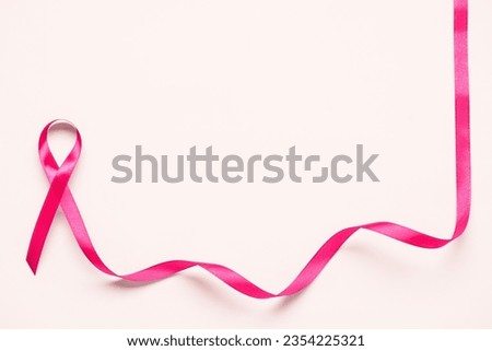 Pink awareness ribbon on white background. Breast cancer concept