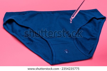 Urinary incontinence, water droplets and women's menstrual underwear Royalty-Free Stock Photo #2354235775
