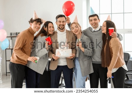 Group of business people with Birthday cake at party in office