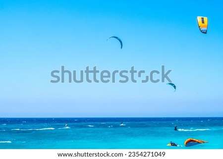 Paralia Agios Ioannis. Kite-surfing beach in Greece. Kite-surfing against a beautiful sea. Many silhouettes of kites in the sky. Travel concept. Artistic picture. Beauty world. 