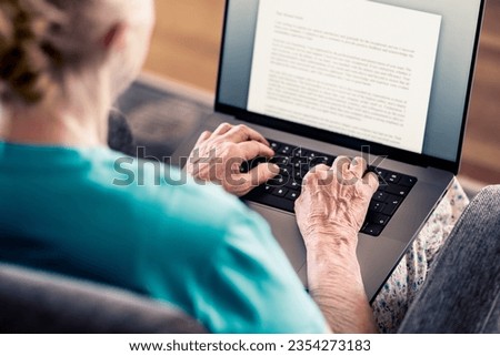 Old senior woman using laptop computer to write text. Book, testament, letter or journal. Elder writer with notebook pc. Mature lady working from home or studying. Hands on notebook keyboard. Royalty-Free Stock Photo #2354273183