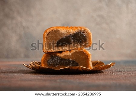 A mooncake  is a Chinese bakery product traditionally eaten during the Mid-Autumn Festival.