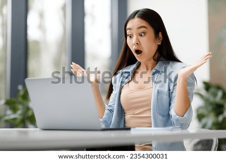 Shocked asian female student using laptop computer, receive good news message, checking exam results online and looking at screen with open mouth Royalty-Free Stock Photo #2354300031