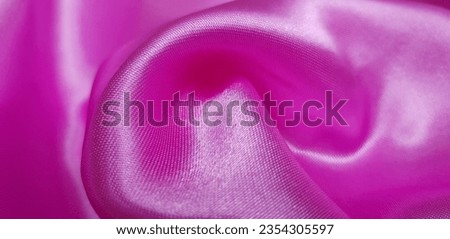Wavy pink silk fabric in  folds (macro, texture).
