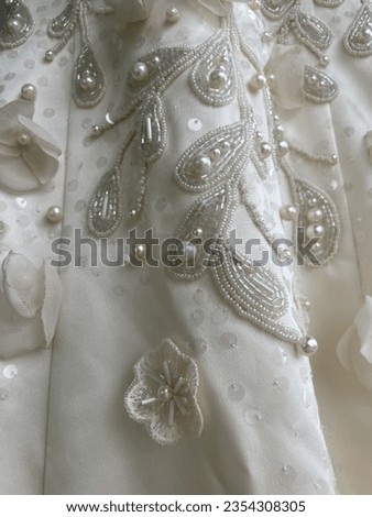 Embroidery with sequins, beads and fabric flowers from chiffon satin wedding dress Royalty-Free Stock Photo #2354308305