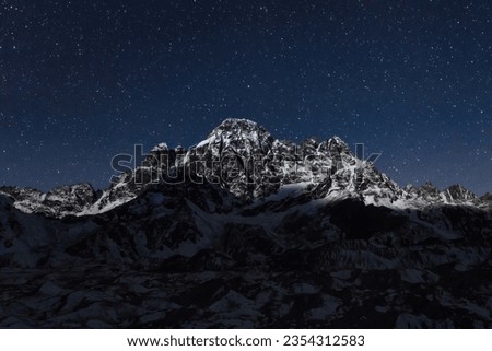 Mountain under starry sky in Himalayas, Nepal. Mountain Himalayan landscape at Night. Everest region.