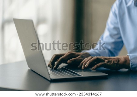 Hands of contemporary young office manager on laptop keyboard during working, surfing net, shopping online or online job. close up pictures