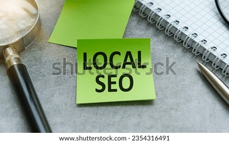 LOCAL SEO text on a sticky on the graph background with pen and magnifier