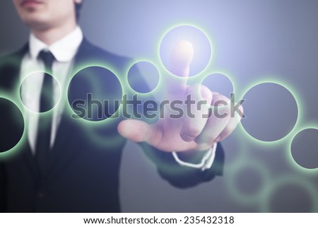 Businessman pressing touch screen interface. selects the circle