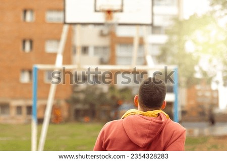 Player looking towards the basketball hoop. Behind. Concept improvement, motivation.