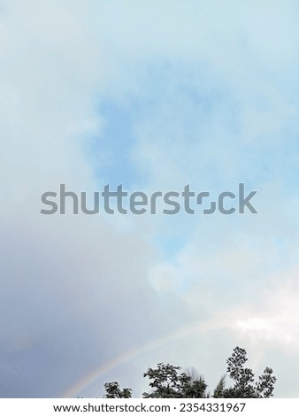 Beautiful rainbow landscape with bright clouds during the day