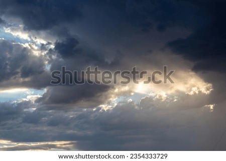 Beautiful crepuscular rays, sun beams shining through holes in the clouds and creating a heaven like effect. Monsoon skies with gorgeous cloudscapes and sun beams with a heavenly feeling.  