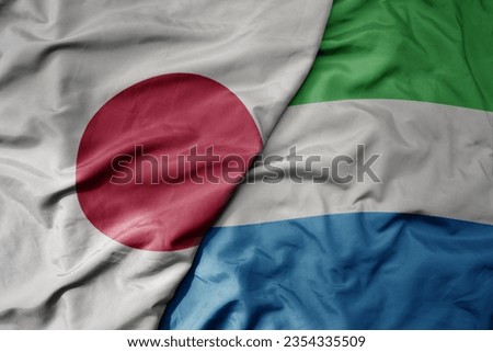 big waving national colorful flag of japan and national flag of sierra leone . macro
