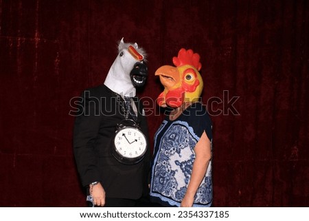 Photo Booth. People wear Horse Head and Chicken Head Masks and pose and play while their pictures are taken in a Photo Booth. Party Photo Booth. Wedding Photo Booth. Holiday. Horsing Around. Fun Time
