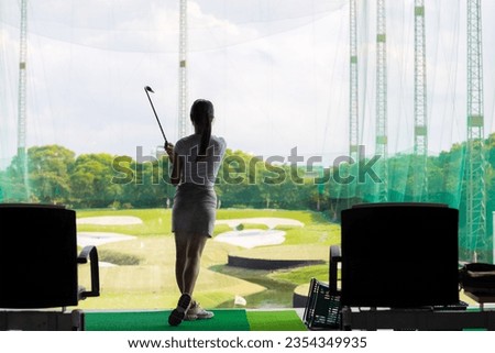 Woman practice golf in golf driving range  Royalty-Free Stock Photo #2354349935