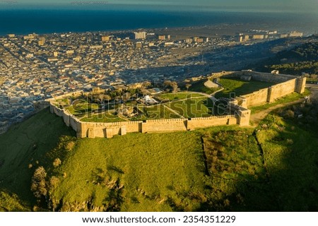 Ancient defensive citadel on a hill in Derbent from above. Evening sunlight Royalty-Free Stock Photo #2354351229
