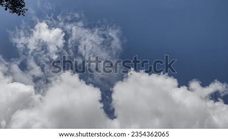 Majestic white fluffy clouds sailing on the endless Blue sky in a bright sunny day. Blue background, peaceful picture,horizontal view.Lovely, eye soothing pictures of Sky.Awesome nature. Nice weather.