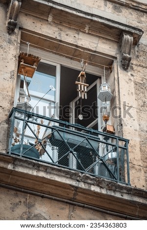 Beautiful balcony window with wind chimes and lamps. Decorative objects or outdoor furniture. Feelings of calm and tranquility. Royalty-Free Stock Photo #2354363803