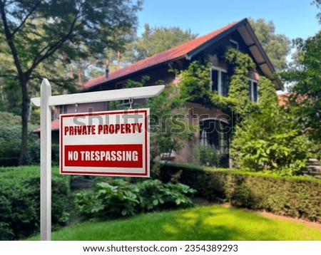 Sign with text Private Property No Trespassing near house