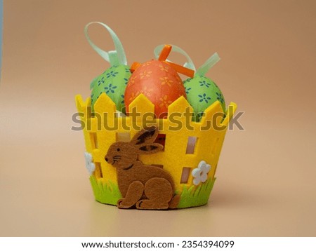 Easter basket with decorative eggs on an orange background. Easter decoration.