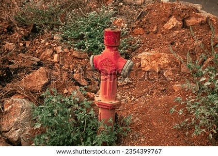 Photo of old fire extinguishing equipment in open area.