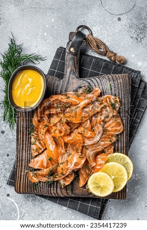 Gravlax Cured Salmon fillet with dill, salt and papper, lox. Gray background. Top view. Royalty-Free Stock Photo #2354417239