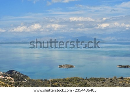 Island on the Skadar Lake panorama. Sunny and cloudy summer day travel and holidays photography. Beautiful background scenery.