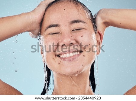 Shower, face or happy woman cleaning hair for skincare or wellness in studio on blue background. Shampoo, beauty model or wet female person washing or grooming for healthy natural hygiene to relax