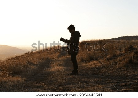 Photograph silhouette of photographer in a sunset in the mountains of Peru. Concept of lifestyles, professions and nature.