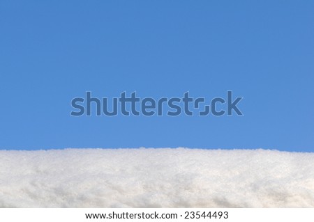 Blue sky and white snow background. Its real snow with it's finish. There is free space for your information or design