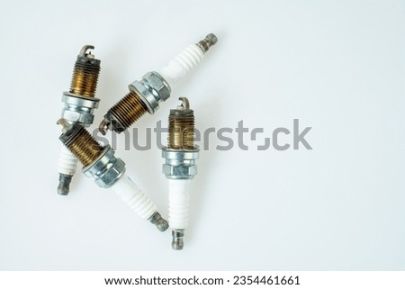 Group of old very damaged car spark plugs, close-up of old used car spark plugs that don't work well isolated on white background, top view