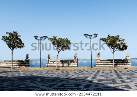 view from Castelmola, Sicily on Mediterranean Sea. Plaza or square with geometric sidewalk